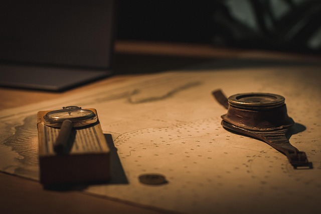 A compass and binoculars on a wooden surface, symbolizing navigation tools.